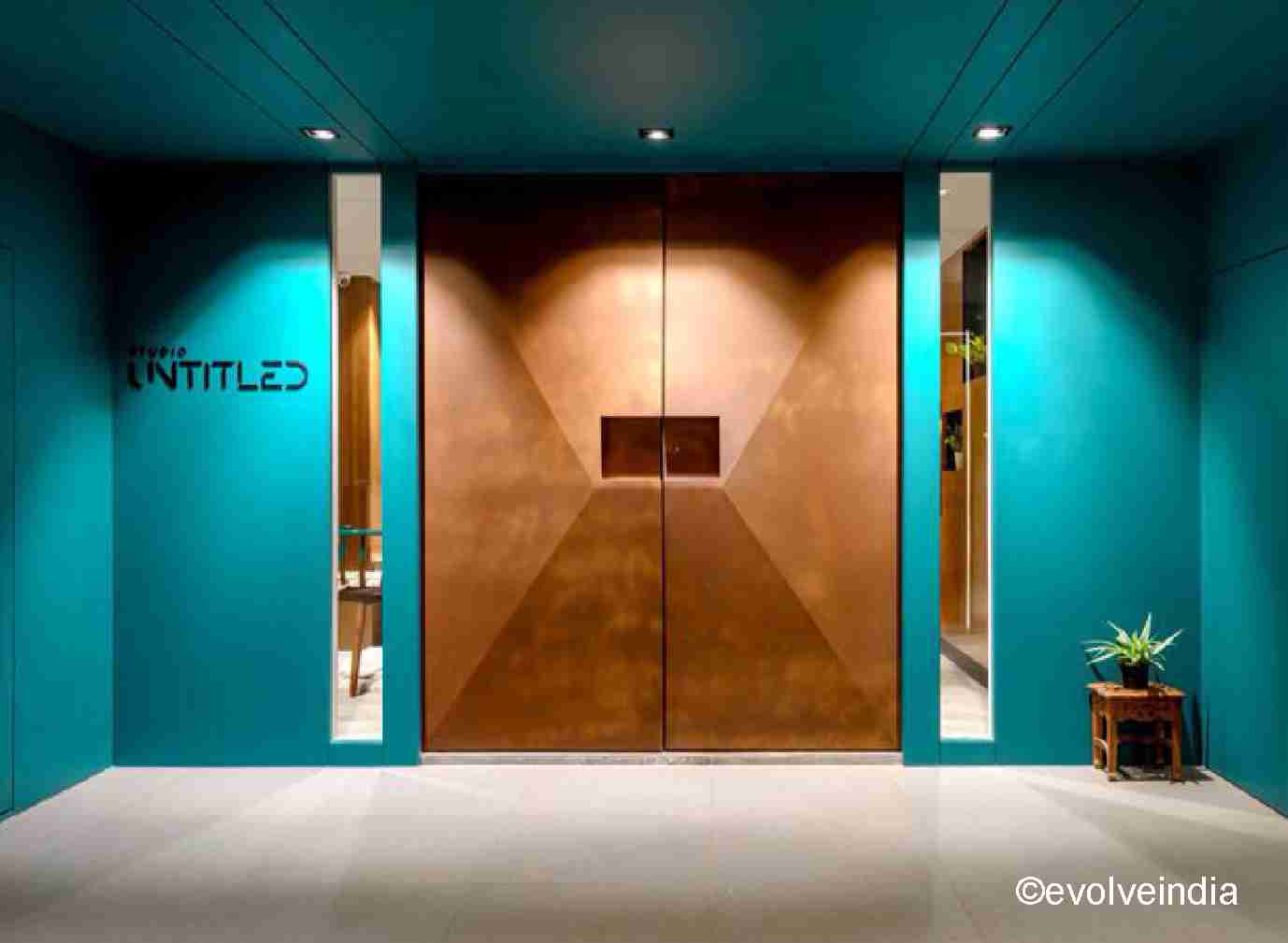 Entrance door designed with rust finish by Evolve India